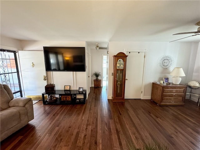 11500 Orchard Rd, Kansas City, MO 64134 - living room featuring dark wood-style floors, a ceiling fan, and baseboards