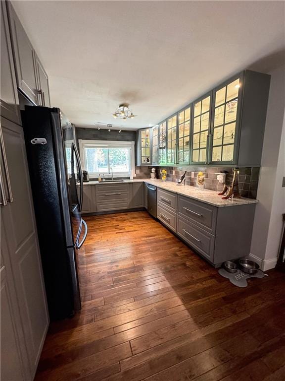 11500 Orchard Rd, Kansas City, MO 64134 - kitchen featuring gray cabinets, freestanding refrigerator, dark wood-style flooring, and a sink