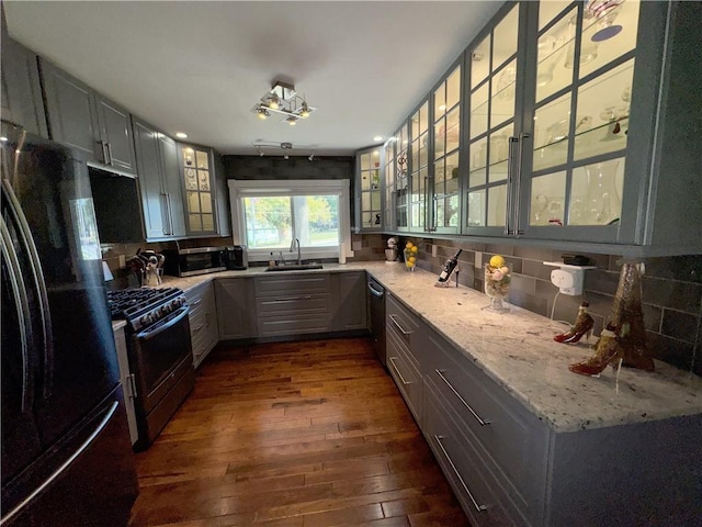 11500 Orchard Rd, Kansas City, MO 64134 - kitchen featuring stainless steel appliances, a sink, dark wood-type flooring, glass insert cabinets, and backsplash