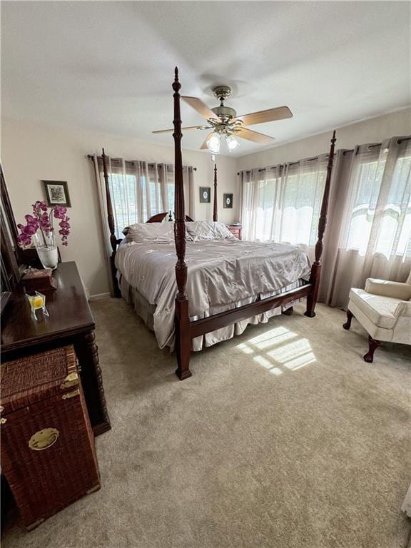 11500 Orchard Rd, Kansas City, MO 64134 - bedroom featuring multiple windows, light carpet, and ceiling fan