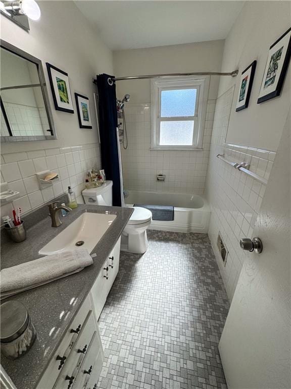 11500 Orchard Rd, Kansas City, MO 64134 - full bath with tile walls, vanity, toilet, shower / tub combo, and a wainscoted wall