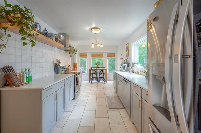 10236 Noland Rd, Lenexa, KS 66215 - kitchen with appliances with stainless steel finishes, open shelves, light countertops, decorative backsplash, and gray cabinets
