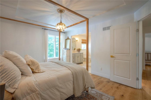 10236 Noland Rd, Lenexa, KS 66215 - bedroom featuring a chandelier, light wood finished floors, ensuite bathroom, and baseboards