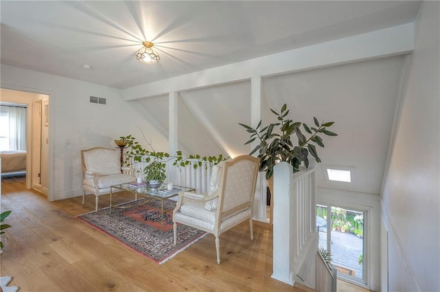 10236 Noland Rd, Lenexa, KS 66215 - sitting room featuring plenty of natural light, wood finished floors, and vaulted ceiling