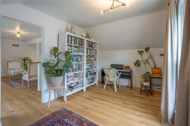 10236 Noland Rd, Lenexa, KS 66215 - office area with wood finished floors, lofted ceiling, baseboards, and a chandelier