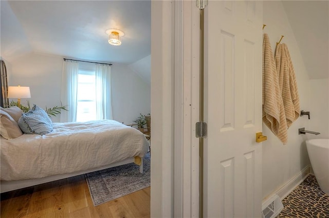 10236 Noland Rd, Lenexa, KS 66215 - bedroom featuring vaulted ceiling and wood finished floors