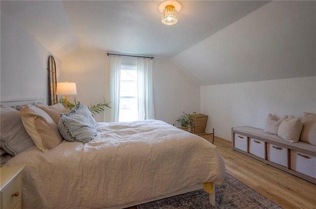 10236 Noland Rd, Lenexa, KS 66215 - bedroom with lofted ceiling and light wood-style floors