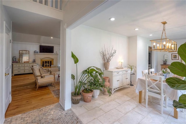 10236 Noland Rd, Lenexa, KS 66215 - dining area with a chandelier, recessed lighting, and a glass covered fireplace