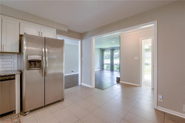 5112 Rock Creek Ln, Mission, KS 66205 - kitchen featuring stainless steel appliances, white cabinets, baseboards, and light stone counters