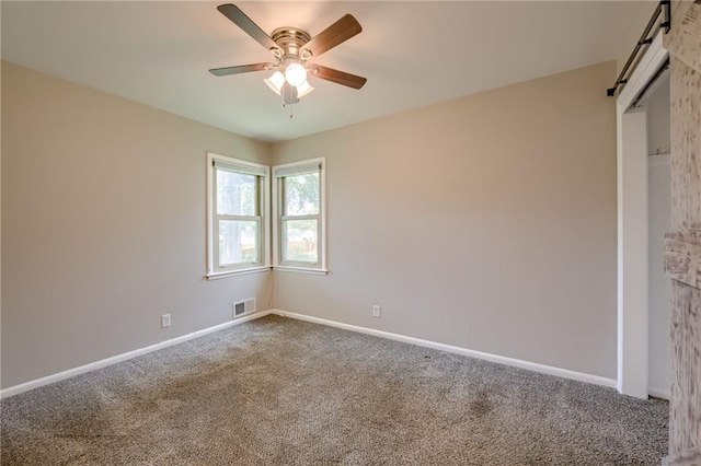 5112 Rock Creek Ln, Mission, KS 66205 - carpeted spare room featuring ceiling fan, baseboards, and a barn door
