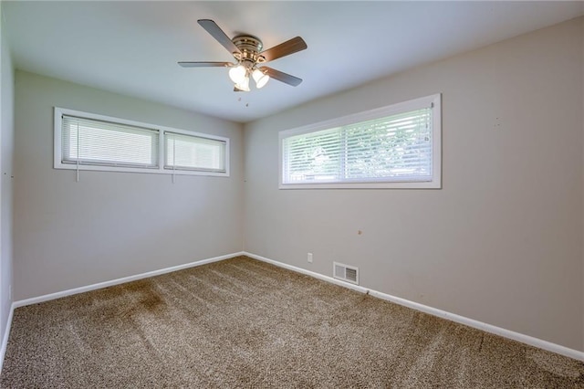 5112 Rock Creek Ln, Mission, KS 66205 - spare room featuring carpet floors, baseboards, and a ceiling fan