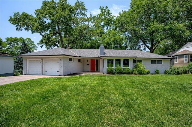 5112 Rock Creek Ln, Mission, KS 66205 - ranch-style house featuring an attached garage, a front yard, a chimney, brick siding, and concrete driveway