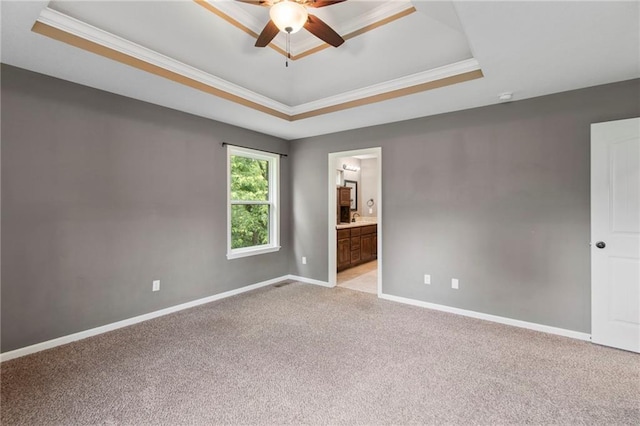 9 Platte Ridge Ct, Edgerton, MO 64444 - empty room with a tray ceiling, light carpet, ornamental molding, a ceiling fan, and baseboards