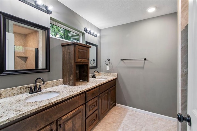 9 Platte Ridge Ct, Edgerton, MO 64444 - full bath with double vanity, baseboards, and a textured ceiling