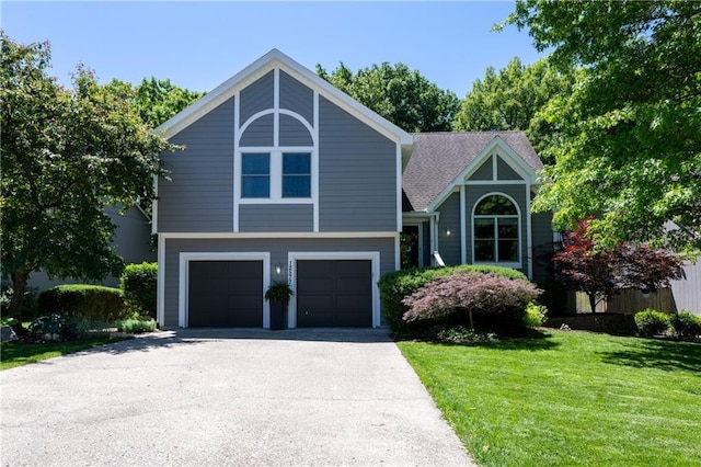 12577 S Alcan Cir, Olathe, KS 66062 - view of front of home featuring a garage, a front yard, and driveway