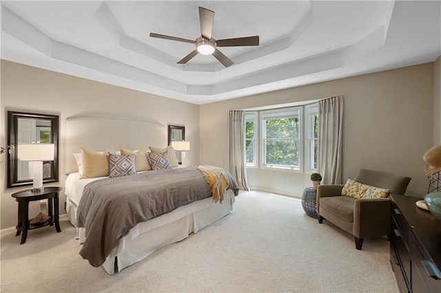 12577 S Alcan Cir, Olathe, KS 66062 - bedroom with a raised ceiling, light colored carpet, and ceiling fan