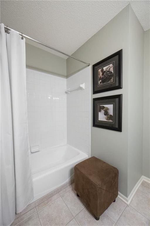 12577 S Alcan Cir, Olathe, KS 66062 - bathroom featuring a textured ceiling, tile patterned flooring, and shower / bath combo with shower curtain