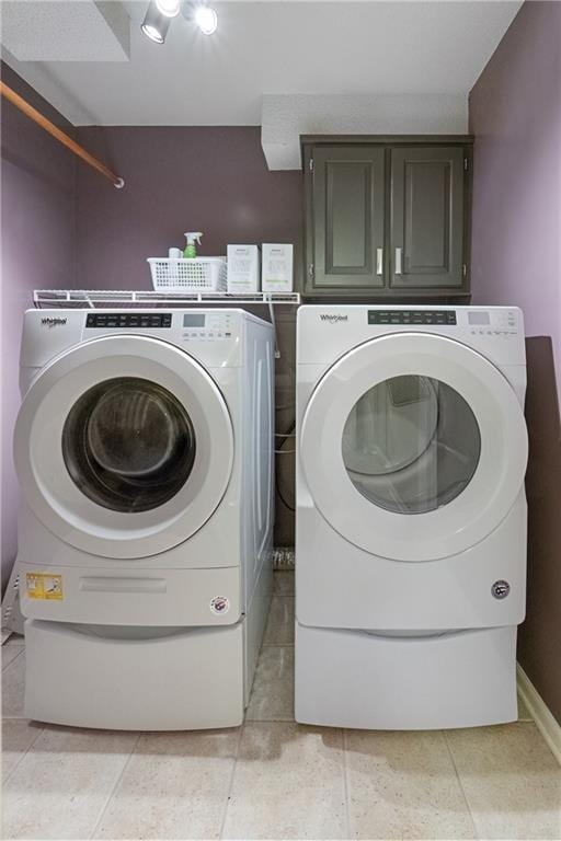 12577 S Alcan Cir, Olathe, KS 66062 - laundry room with washer and clothes dryer, cabinet space, and light tile patterned flooring