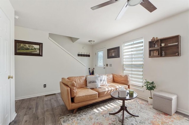3486 SW Wysteria Ter, Lees Summit, MO 64082 - living area featuring wood finished floors, ceiling fan, and stairway