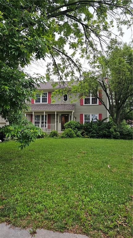 15320 W 92nd Pl, Lenexa, KS 66219 - colonial home with covered porch and a front lawn