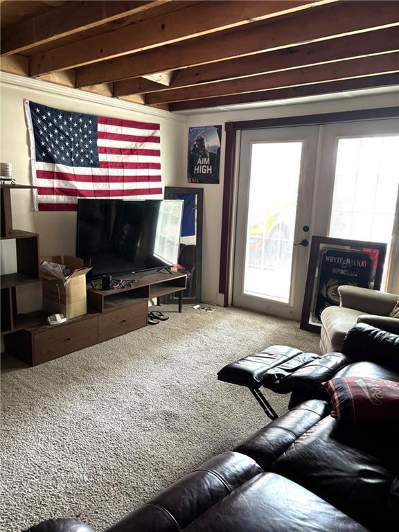 1024 Iowa St, Lawrence, KS 66044 - carpeted living room featuring beamed ceiling
