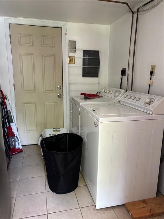 1024 Iowa St, Lawrence, KS 66044 - laundry area with washing machine and dryer and light tile patterned flooring