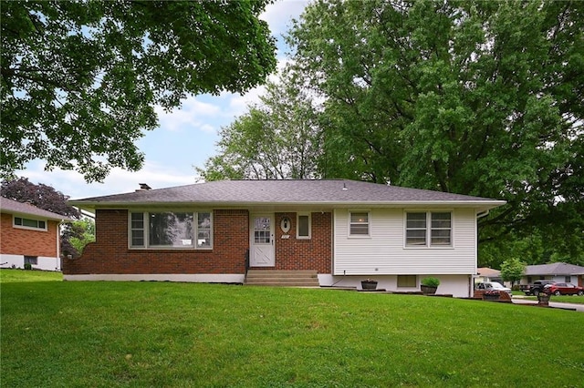 701 N Apache Dr, Independence, MO 64056 - view of front of house with entry steps, a front yard, and brick siding