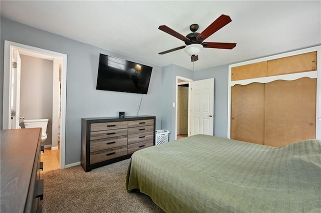 701 N Apache Dr, Independence, MO 64056 - bedroom featuring carpet, a closet, baseboards, ceiling fan, and connected bathroom