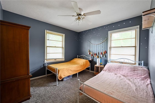 701 N Apache Dr, Independence, MO 64056 - bedroom with carpet, multiple windows, ceiling fan, a textured ceiling, and baseboards