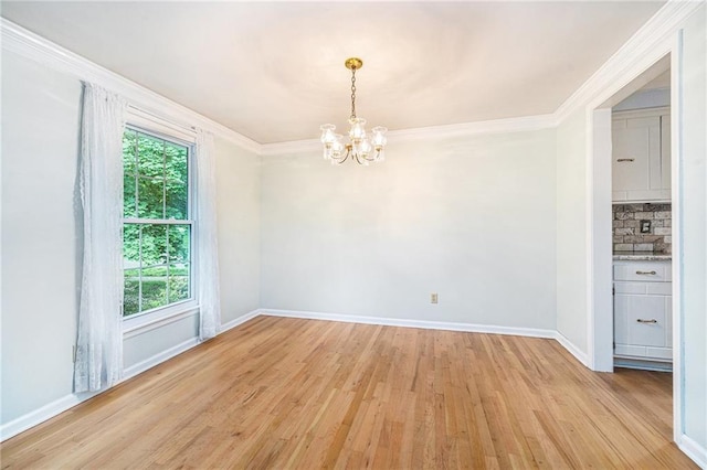 9601 W 97th St, Overland Park, KS 66212 - spare room with a chandelier, light wood finished floors, baseboards, and crown molding
