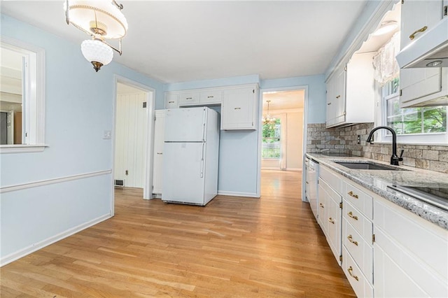 9601 W 97th St, Overland Park, KS 66212 - kitchen with white appliances, a sink, under cabinet range hood, and white cabinets