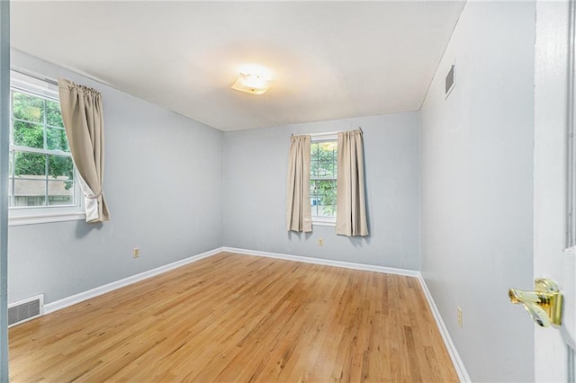 9601 W 97th St, Overland Park, KS 66212 - spare room featuring light wood-style floors, plenty of natural light, and baseboards