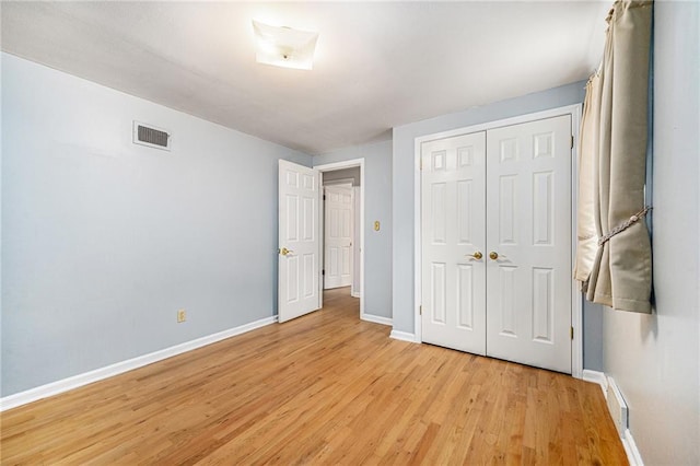 9601 W 97th St, Overland Park, KS 66212 - unfurnished bedroom with light wood-type flooring, baseboards, and a closet