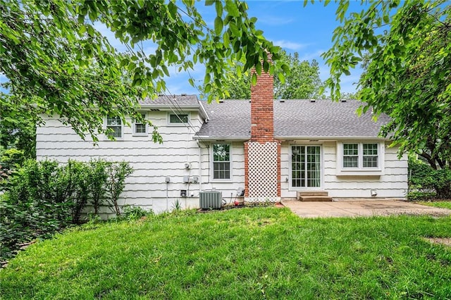 9601 W 97th St, Overland Park, KS 66212 - rear view of property with a patio area, a yard, a chimney, a shingled roof, and central air condition unit