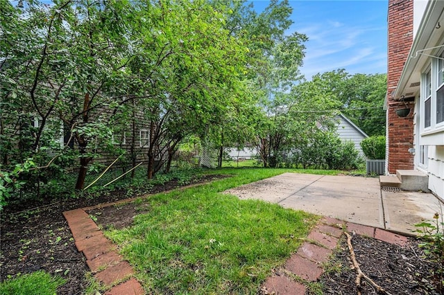9601 W 97th St, Overland Park, KS 66212 - view of grassy yard featuring a patio and central AC