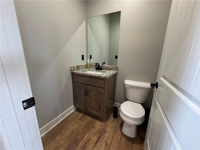 6601 Lakeside Cir, Odessa, MO 64076 - bathroom with toilet, wood finished floors, vanity, and baseboards