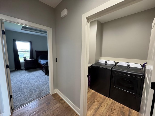 6601 Lakeside Cir, Odessa, MO 64076 - washroom with washing machine and dryer, wood finished floors, and baseboards
