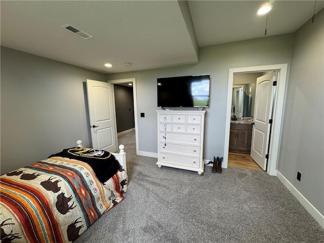 6601 Lakeside Cir, Odessa, MO 64076 - carpeted bedroom featuring baseboards, ensuite bathroom, and recessed lighting