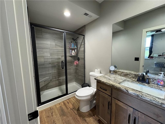 6601 Lakeside Cir, Odessa, MO 64076 - full bathroom featuring toilet, vanity, wood finished floors, and a shower stall