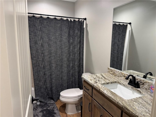 6601 Lakeside Cir, Odessa, MO 64076 - full bath with vanity, toilet, wood finished floors, and shower / tub combo with curtain