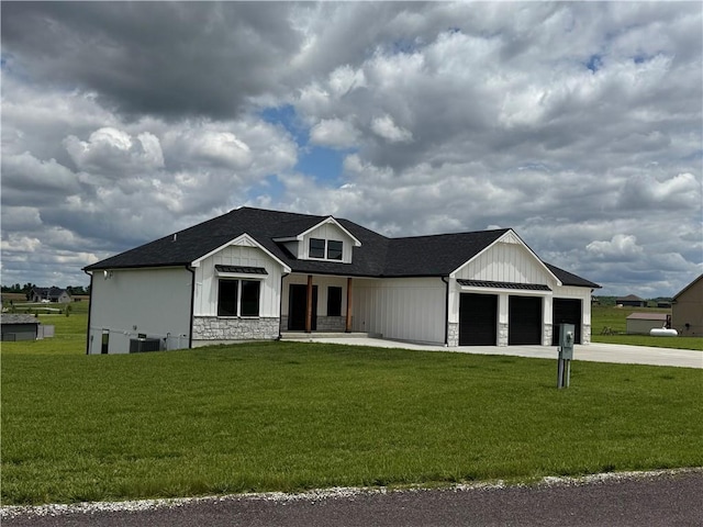 6601 Lakeside Cir, Odessa, MO 64076 - modern inspired farmhouse with stone siding, a garage, driveway, a front yard, and board and batten siding