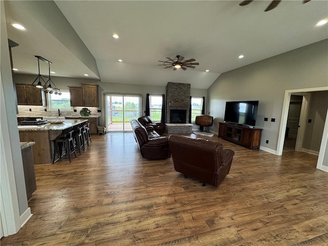 6601 Lakeside Cir, Odessa, MO 64076 - living area with a ceiling fan, lofted ceiling, dark wood finished floors, recessed lighting, and a stone fireplace