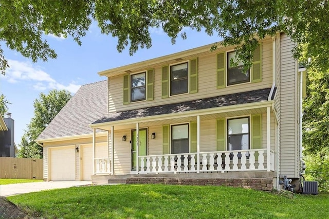 1305 N Hunter Dr, Olathe, KS 66061 - traditional-style home featuring a porch, concrete driveway, a front yard, and an attached garage