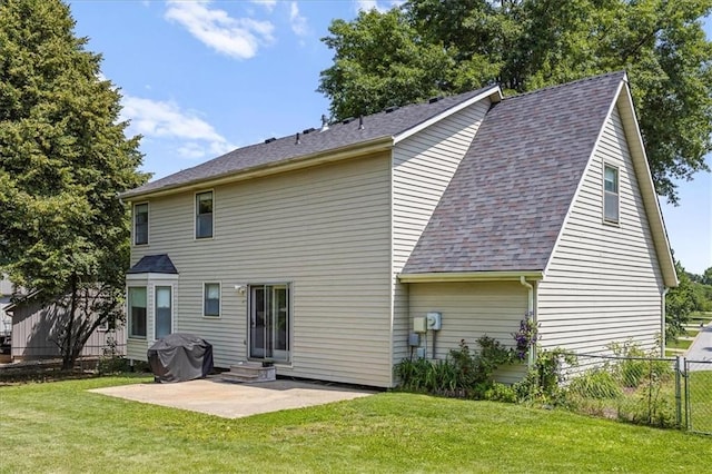 1305 N Hunter Dr, Olathe, KS 66061 - rear view of house featuring a patio, entry steps, and roof with shingles