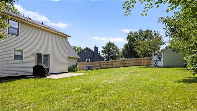 1305 N Hunter Dr, Olathe, KS 66061 - view of yard featuring a storage unit and a patio