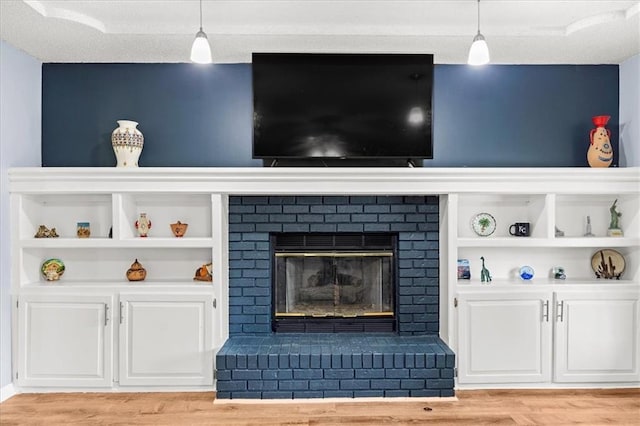 1305 N Hunter Dr, Olathe, KS 66061 - living room with light wood-type flooring and a brick fireplace