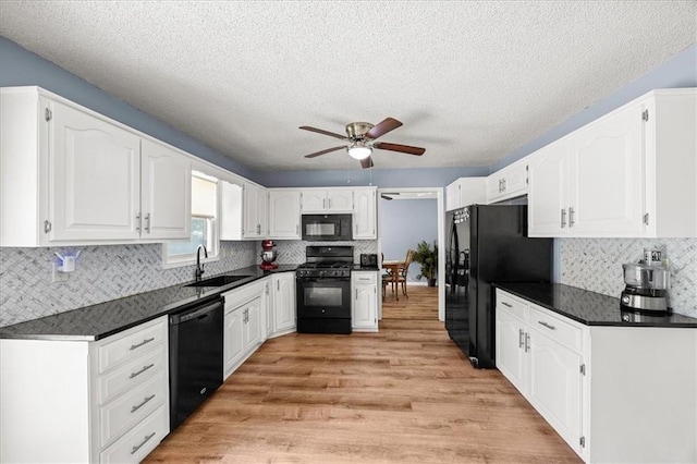 1305 N Hunter Dr, Olathe, KS 66061 - kitchen featuring black appliances, dark countertops, ceiling fan, white cabinets, and a textured ceiling