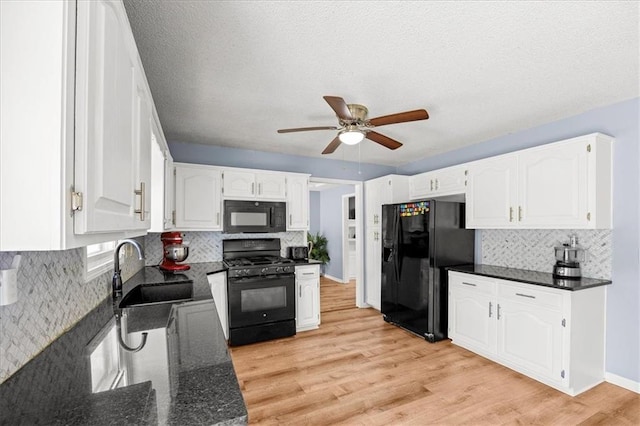 1305 N Hunter Dr, Olathe, KS 66061 - kitchen with black appliances, ceiling fan, tasteful backsplash, white cabinetry, and a textured ceiling