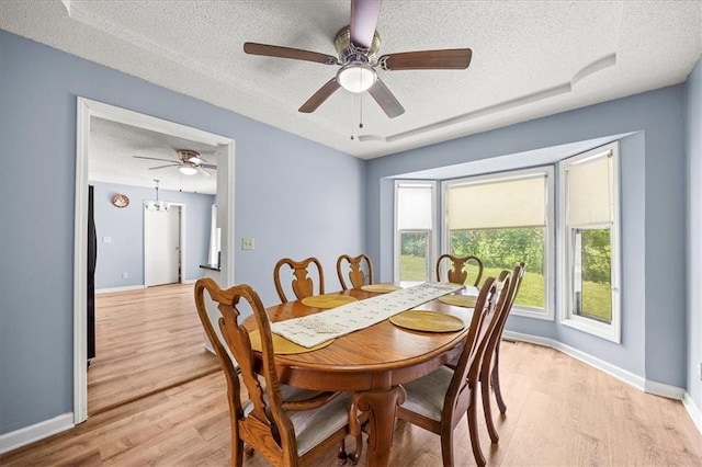 1305 N Hunter Dr, Olathe, KS 66061 - dining area featuring a textured ceiling, light wood finished floors, and ceiling fan