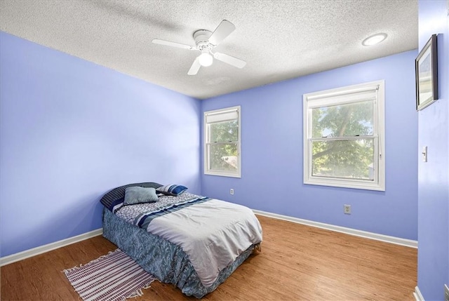 1305 N Hunter Dr, Olathe, KS 66061 - bedroom with a textured ceiling, wood finished floors, and ceiling fan